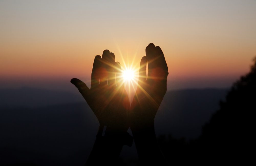 spiritual-prayer-hands-sun-shine-with-blurred-beautiful-sunset spiritual-prayer-hands-sun-shine-with-blurred-beautiful-sunset